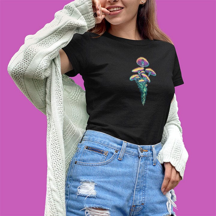 Woman wearing luminous mushrooms rising from the soil black t-shirt for quiet power and natural radiance.