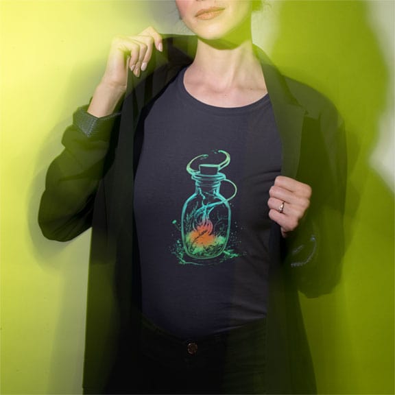 Woman wearing glowing bottle with swirling cosmic magic on navy t-shirt for boundless energy contained magic spiritual defiance