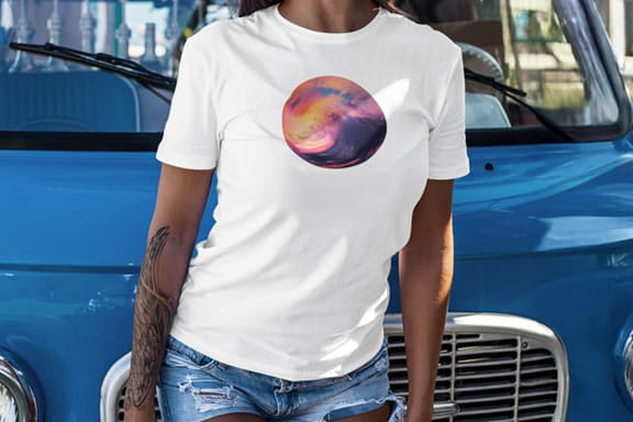 Woman wearing sunset wave circular white t-shirt for coming ocean sunrises and new beginnings.