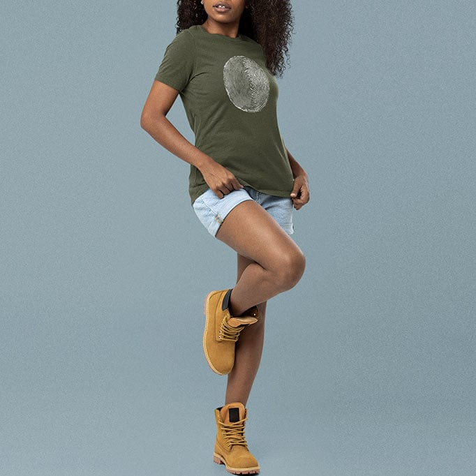 Woman wearing tree ring and thumbprint design on olive green t-shirt for nature identity growth layers