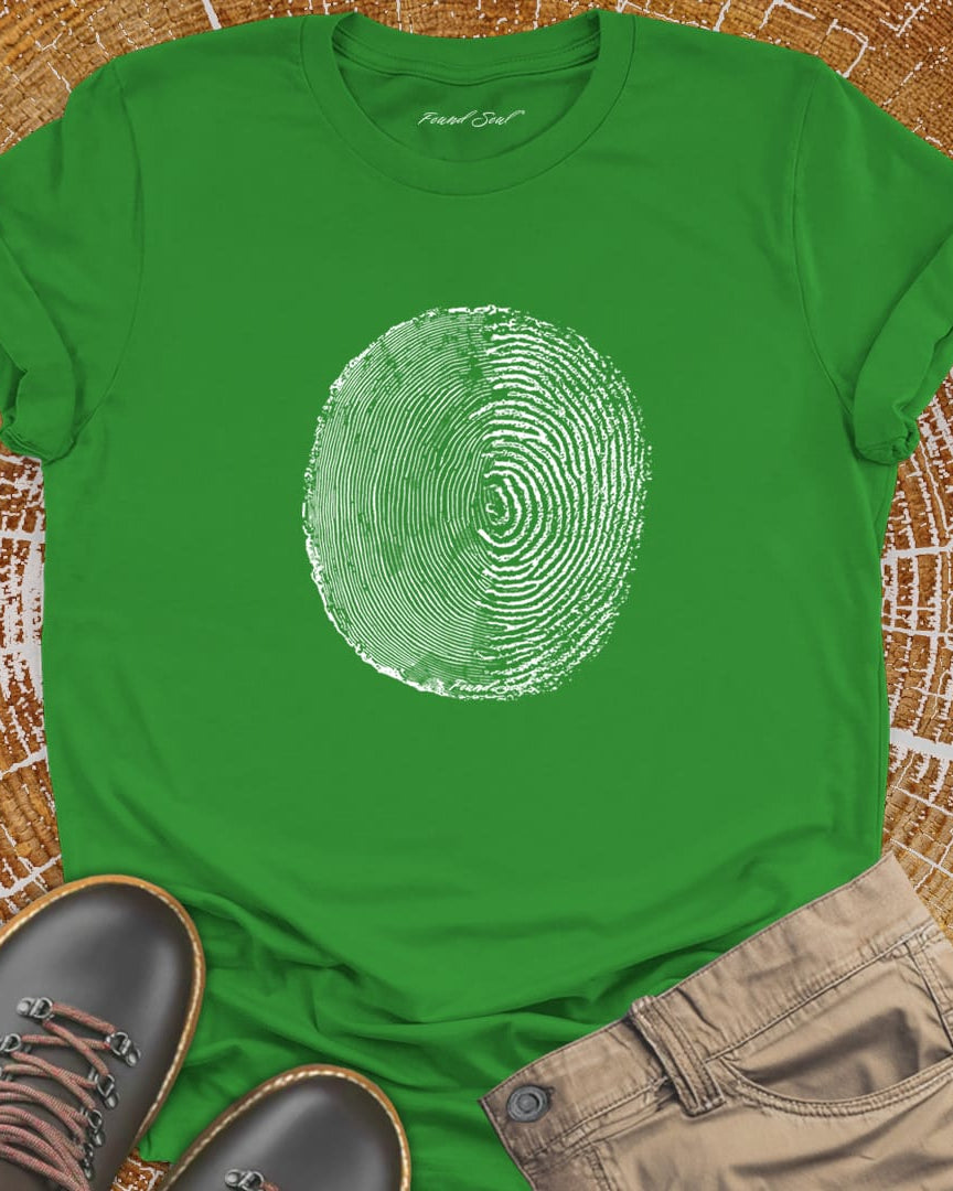 Tree ring and thumbprint design on green t-shirt for nature identity growth layers