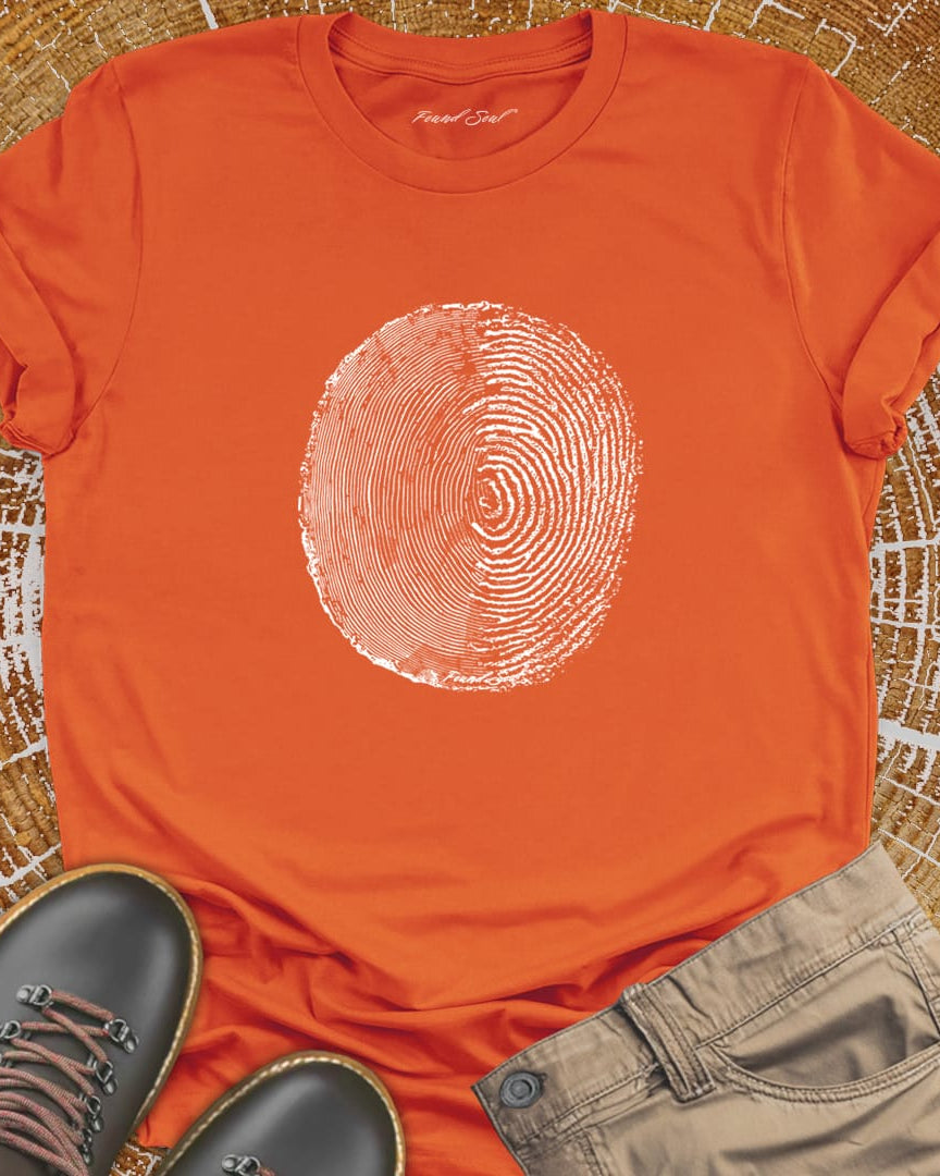 Tree ring and thumbprint design on orange t-shirt for nature identity growth layers