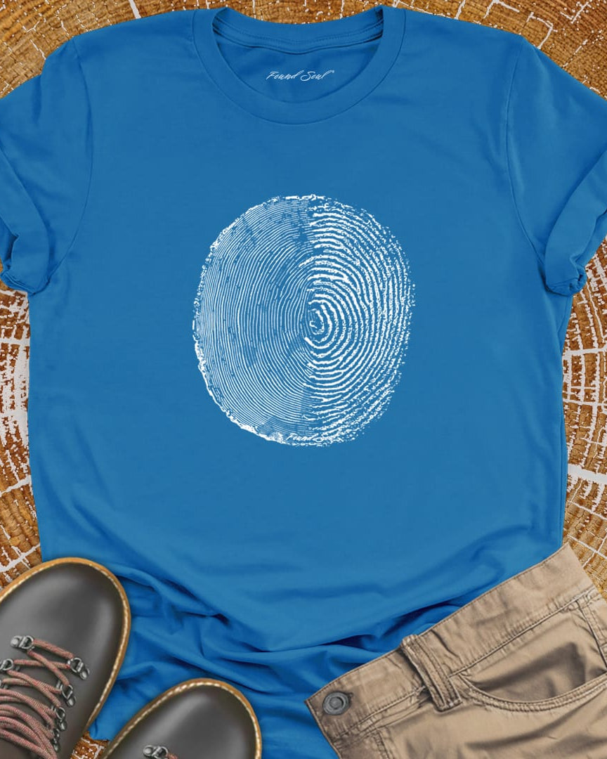 Tree ring and thumbprint design on blue t-shirt for nature identity growth layers