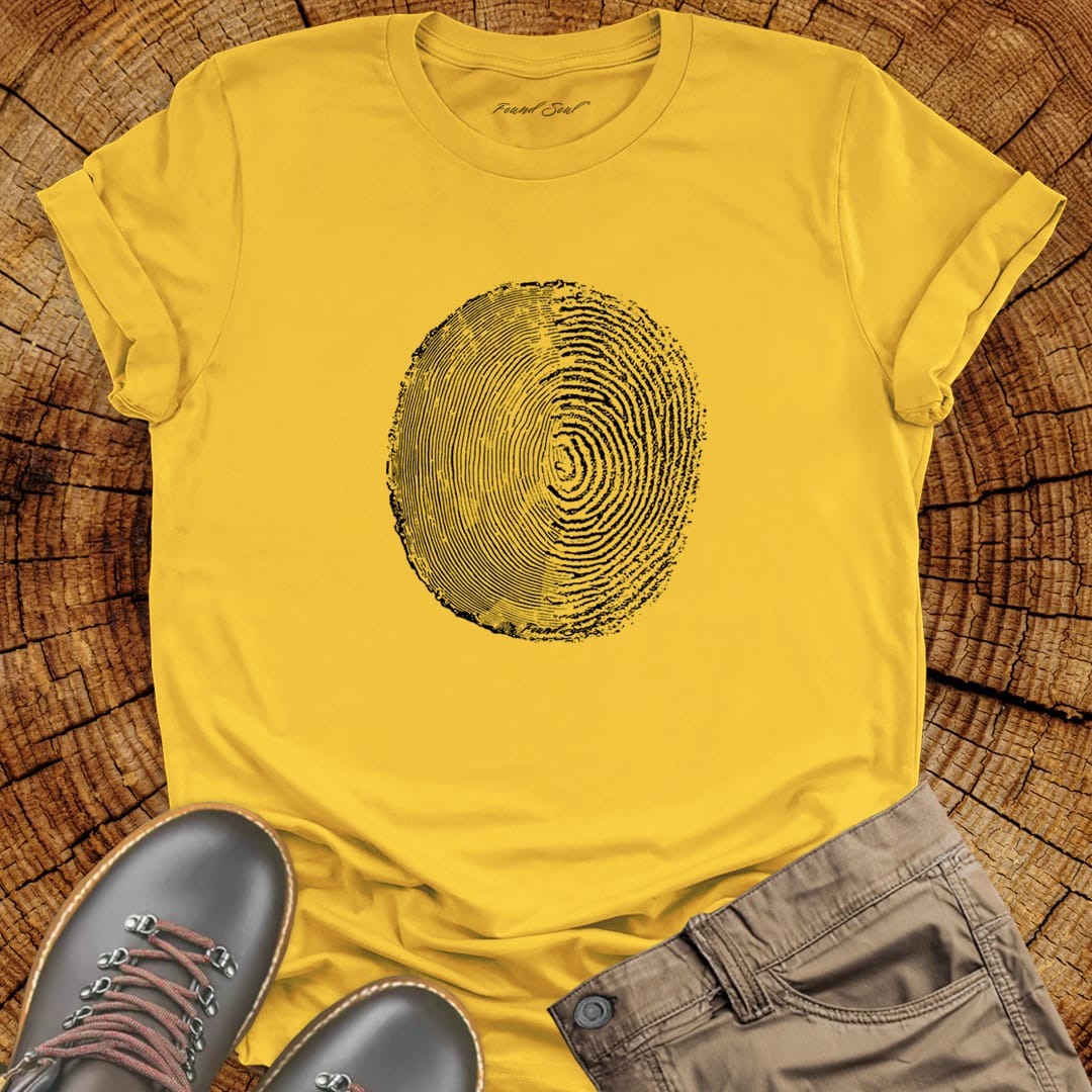 Tree ring and thumbprint design in white on yellow t-shirt for nature identity growth layers spiritual connection