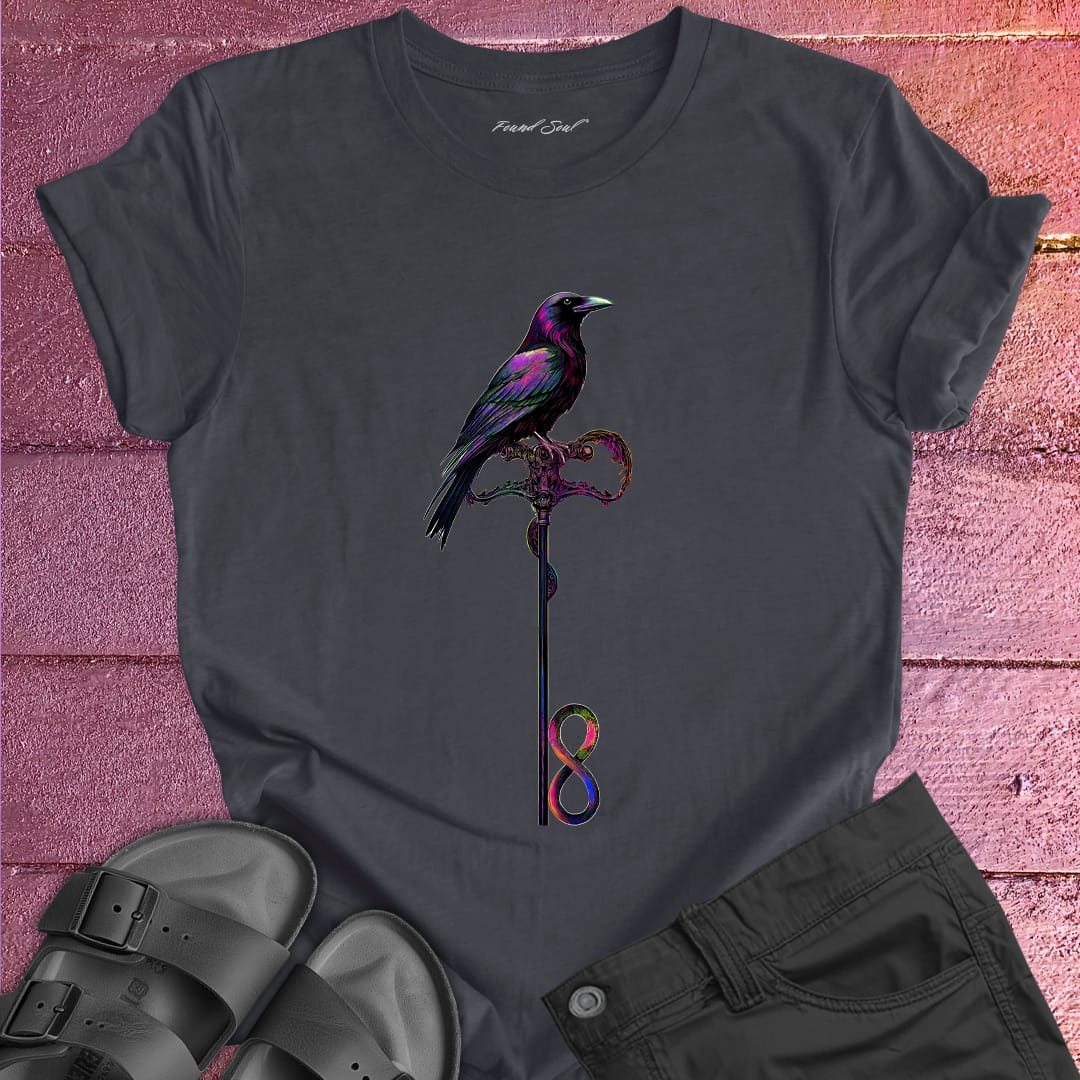 Vibrant bird perched on infinity symbol key on dark grey t-shirt for freedom access unlocking infinity spiritual liberation key