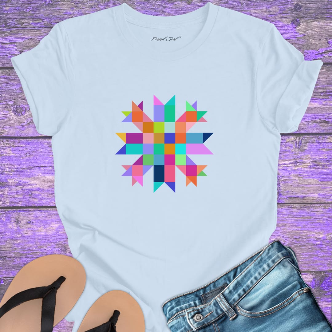 Vibrant mosaic geometric star with colorful angular pieces on light blue t-shirt for healing wholeness transformation sacred geometry