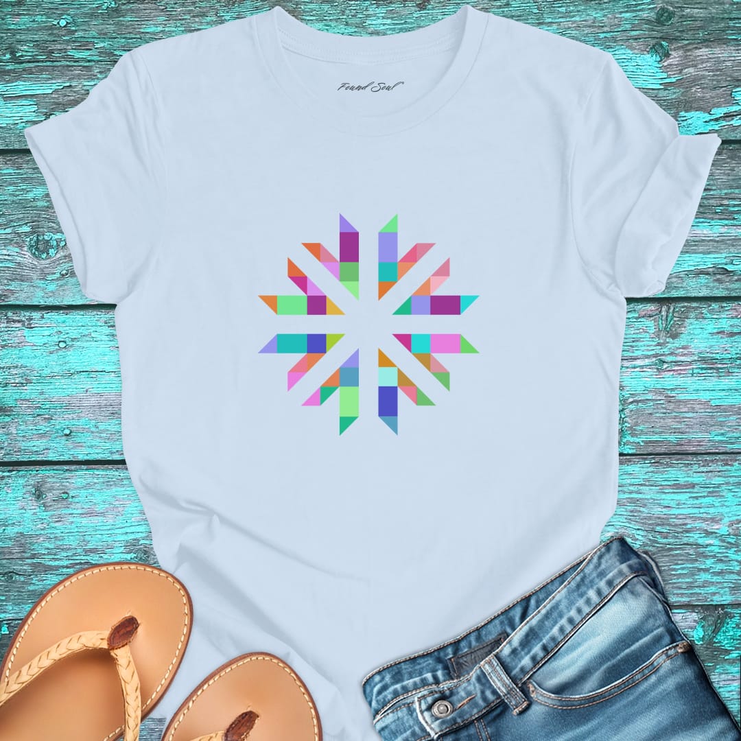 Vibrant geometric starburst radiating on light blue t-shirt for color frequency sacred geometry visual harmony