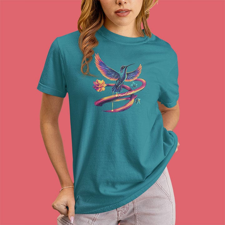 Woman wearing vibrant hummingbird with flowing rainbow ribbon trails and flower turquoise t-shirt for flow state movement art presence spiritual beauty
