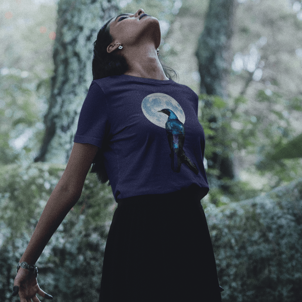 Woman wearing raven in front of full moon on navy t-shirt for night wisdom
