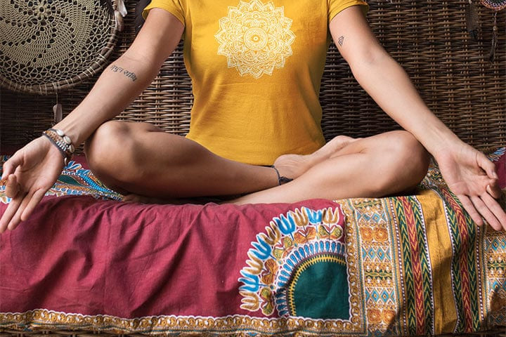 Meditation woman wearing mandala with delicate petal symmetry on yellow t-shirt for meditation consciousness expansion sacred geometry