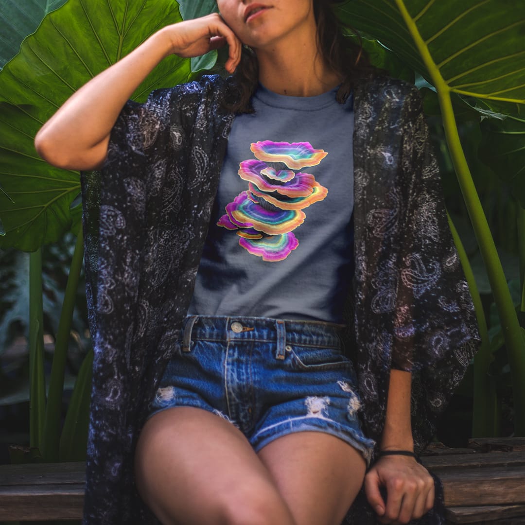 Woman wearing vibrant stacked rainbow turkey tail mushrooms grey t-shirt for layered growth shadow rising mushroom wisdom spiritual building light seeking nature