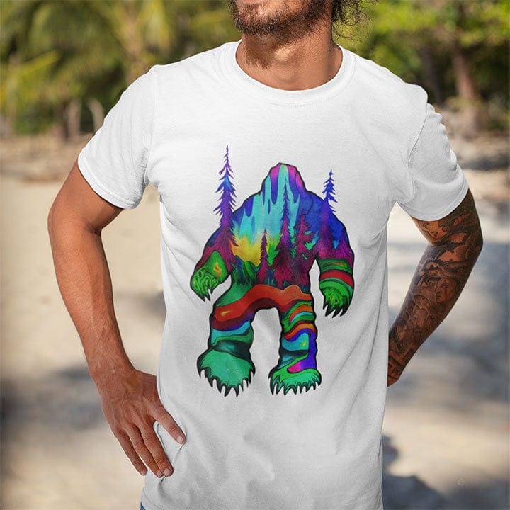 Man wearing bigfoot silhouette filled with aurora borealis and forest landscape on white t-shirt for cryptid mystery wilderness.