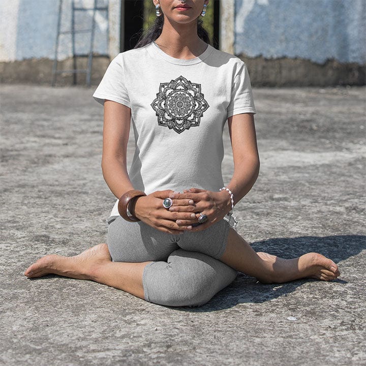Woman wearing intricate mandala with delicate line work on white t-shirt for zen meditation stillness sacred geometry detail awareness