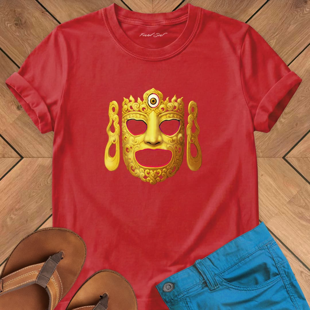 Ornate Buddha ceremonial dance mask on red t-shirt for Buddhist ritual sacred vessel mystery tradition