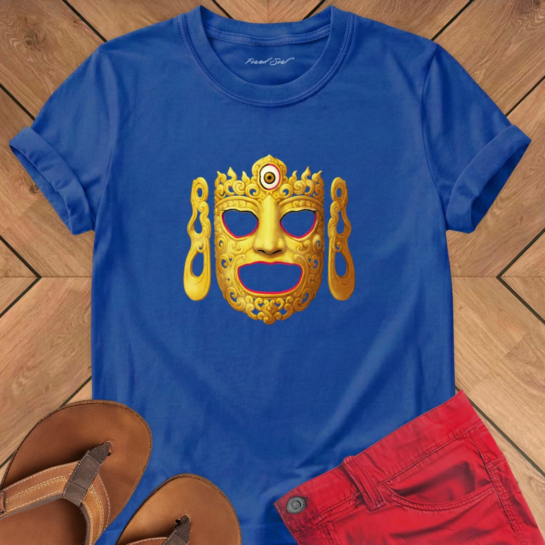 Ornate Buddha ceremonial dance mask on blue t-shirt for Buddhist ritual sacred vessel mystery tradition
