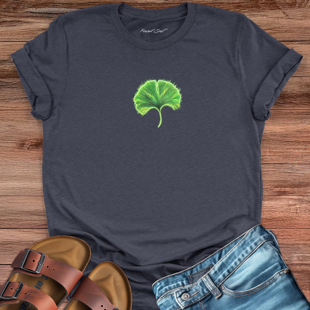 Glowing green ginkgo leaf with radiating light grey t-shirt for renewal and fresh starts.