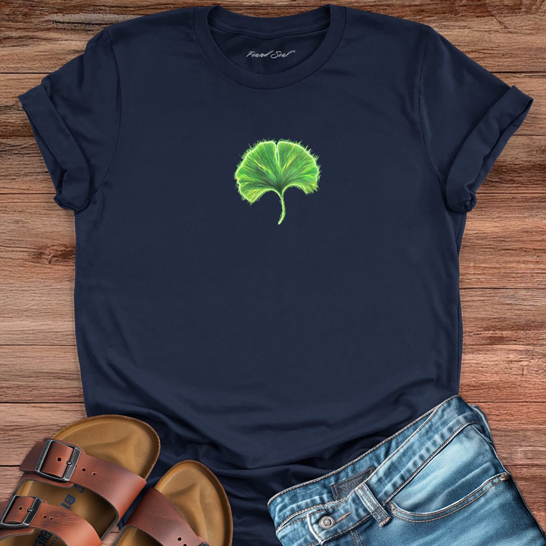 Glowing green ginkgo leaf with radiating light navy t-shirt for renewal and fresh starts.