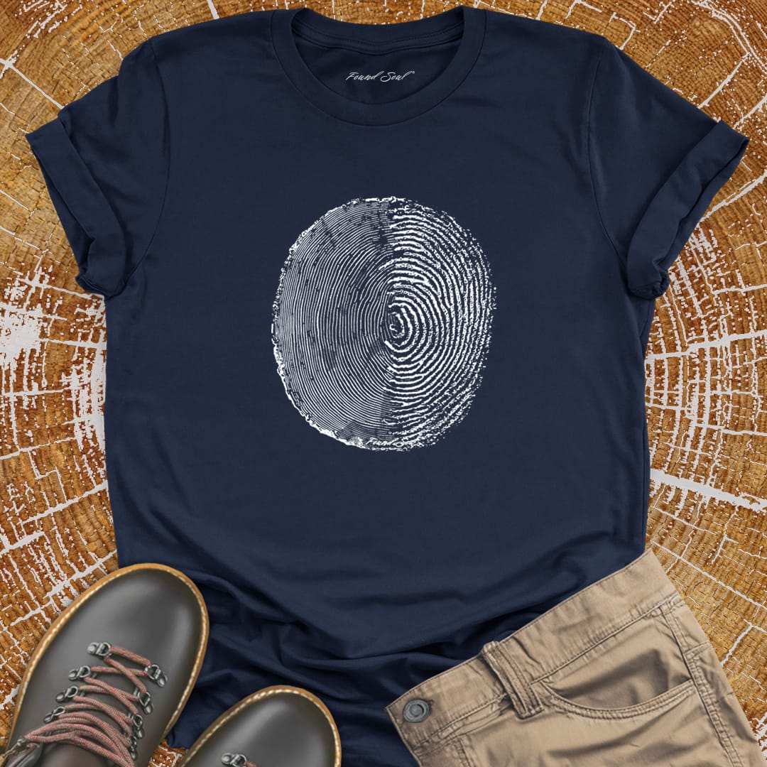 Tree ring and thumbprint design on navy t-shirt for nature identity growth layers
