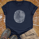 Tree ring and thumbprint design on navy t-shirt for nature identity growth layers