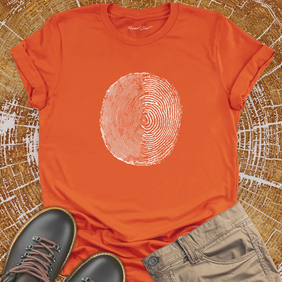 Tree ring and thumbprint design on orange t-shirt for nature identity growth layers