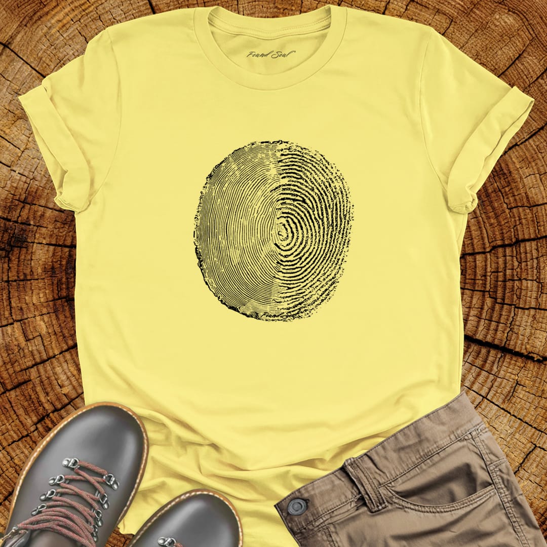 Tree ring and thumbprint design in white on yellow t-shirt for nature identity growth layers spiritual connection