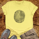 Tree ring and thumbprint design in white on yellow t-shirt for nature identity growth layers spiritual connection