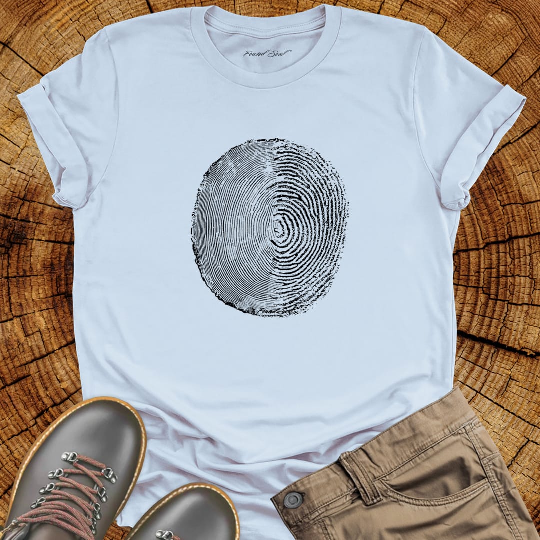 Tree ring and thumbprint design in white on light blue t-shirt for nature identity growth layers spiritual connection