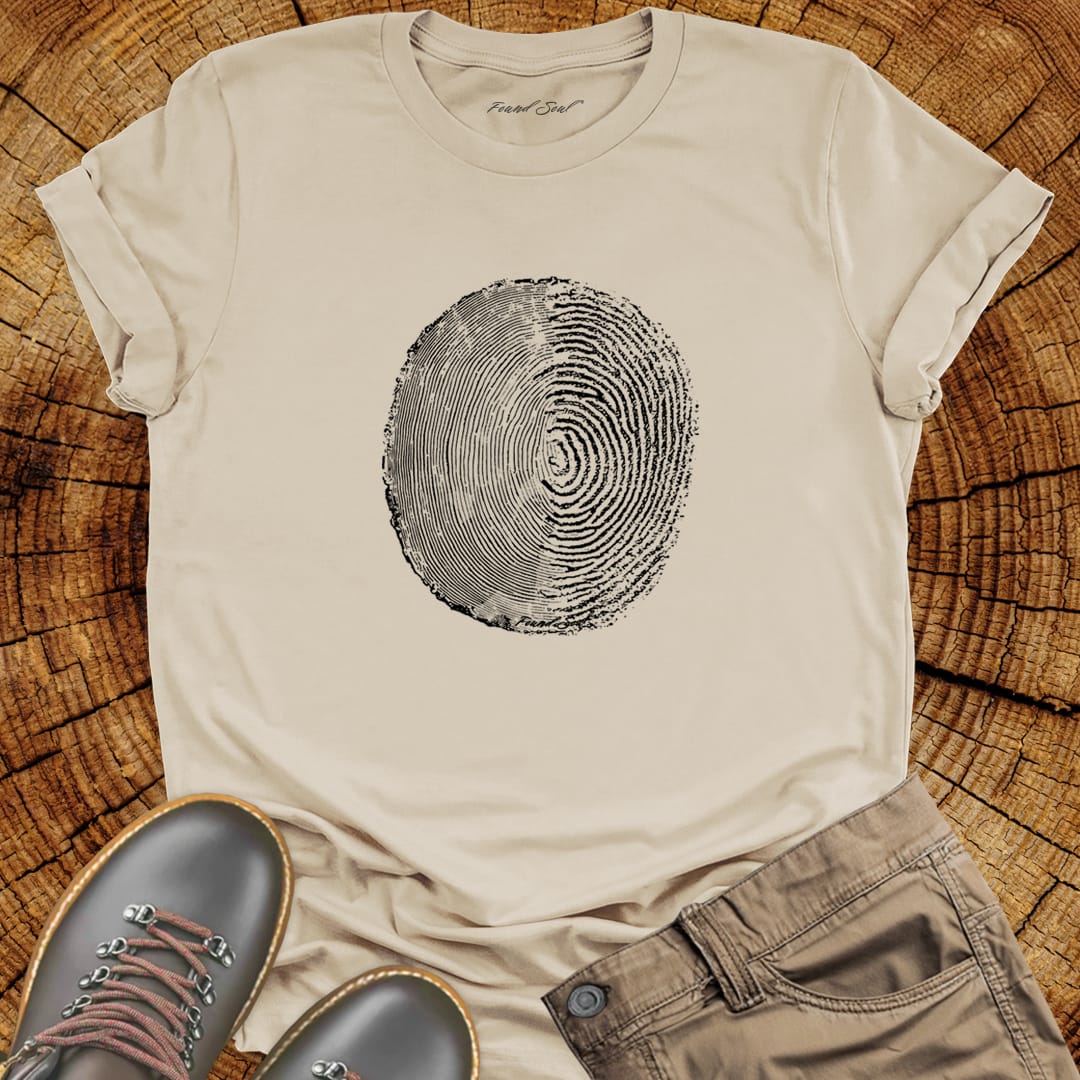 Tree ring and thumbprint design in white on sand t-shirt for nature identity growth layers spiritual connection