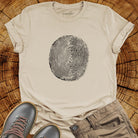 Tree ring and thumbprint design in white on sand t-shirt for nature identity growth layers spiritual connection