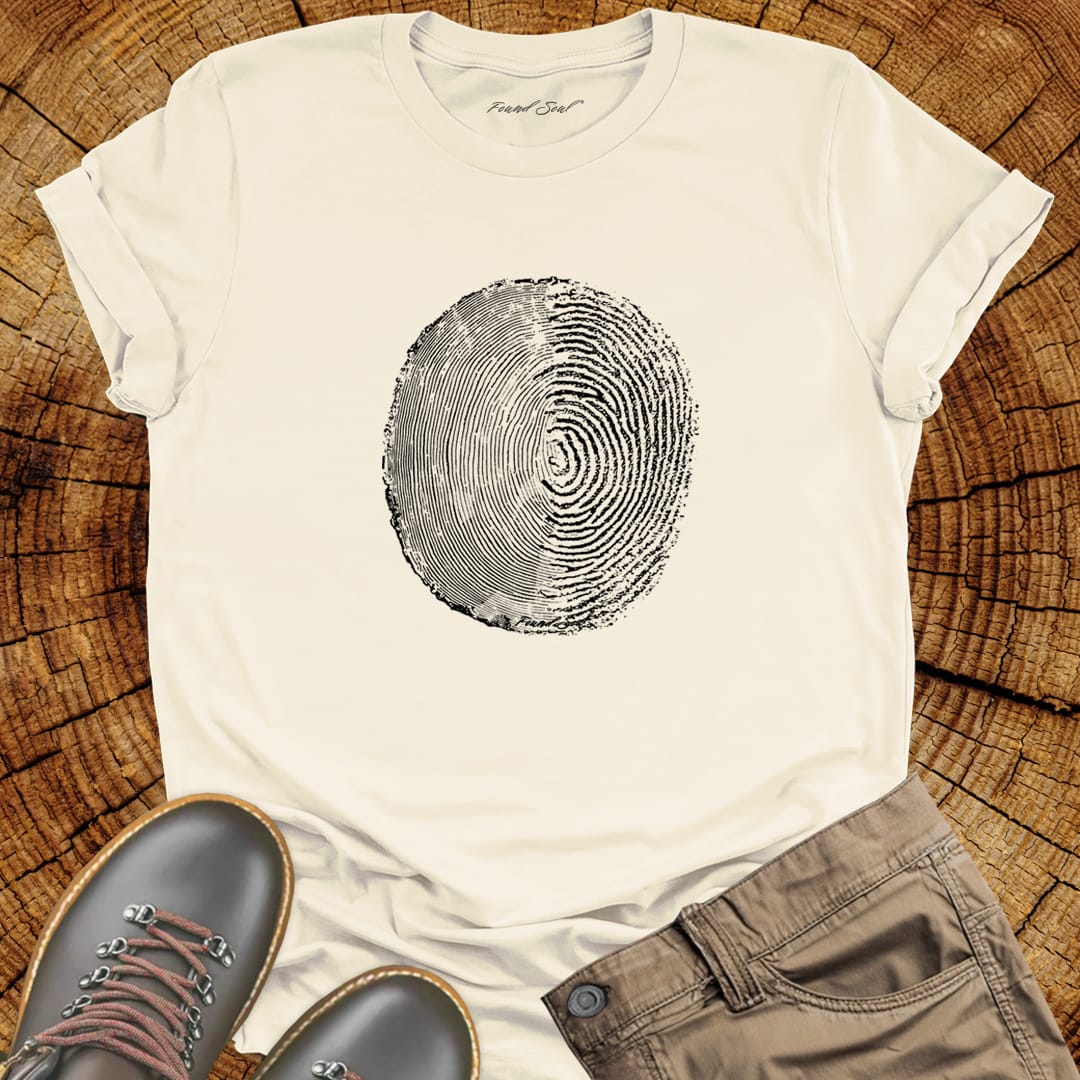 Tree ring and thumbprint design in white on natural t-shirt for nature identity growth layers spiritual connection