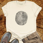 Tree ring and thumbprint design in white on natural t-shirt for nature identity growth layers spiritual connection
