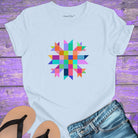 Vibrant mosaic geometric star with colorful angular pieces on light blue t-shirt for healing wholeness transformation sacred geometry