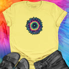 Vibrant rainbow and black spiral mandala on yellow t-shirt for energy frequency.