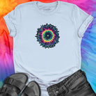 Vibrant rainbow and black spiral mandala on light blue t-shirt for energy frequency.