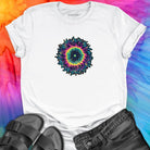 Vibrant rainbow and black spiral mandala on white t-shirt for energy frequency.