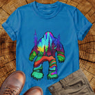 Bigfoot silhouette filled with aurora borealis and forest landscape on blue t-shirt for cryptid mystery wilderness.
