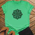 Intricate mandala with delicate line work on green t-shirt for zen meditation stillness sacred geometry detail awareness