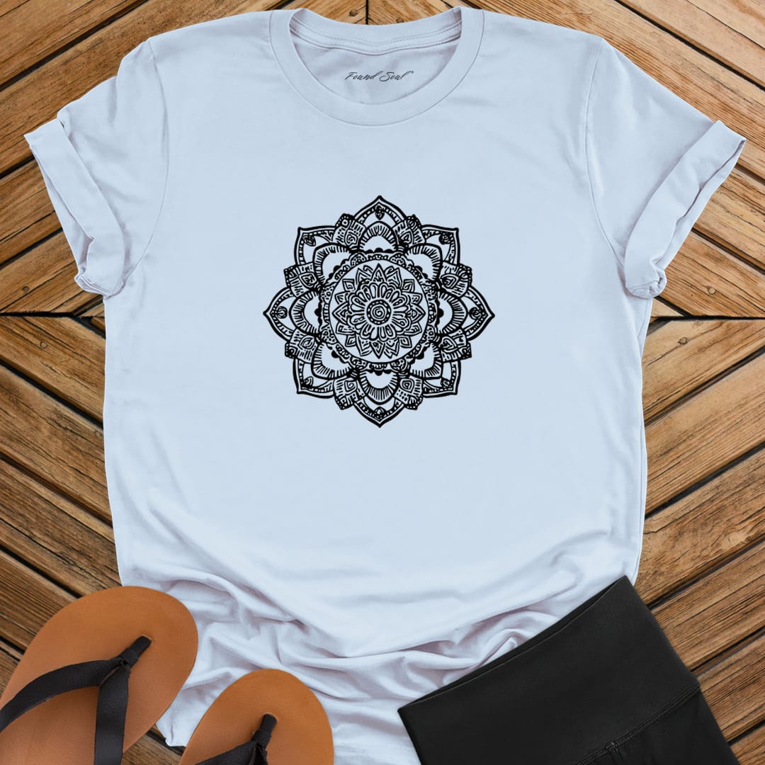 Intricate mandala with delicate line work on light blue t-shirt for zen meditation stillness sacred geometry detail awareness