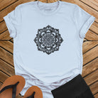 Intricate mandala with delicate line work on light blue t-shirt for zen meditation stillness sacred geometry detail awareness