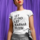 Woman wearing let it go let karma flow white t-shirt for release and trust.